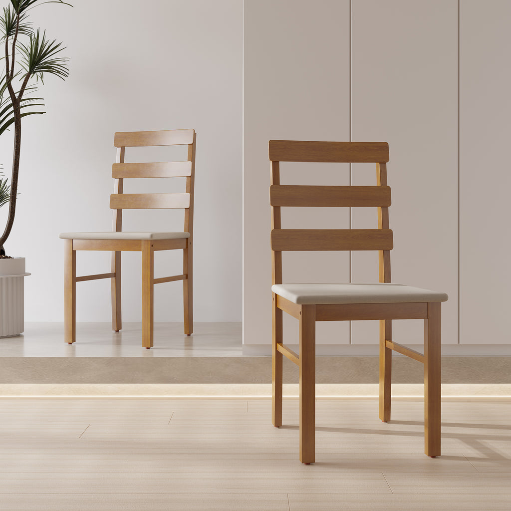 Two solid wood dining chairs with cushioned seats in a minimalist room. Features ladder backrest and sturdy frame.