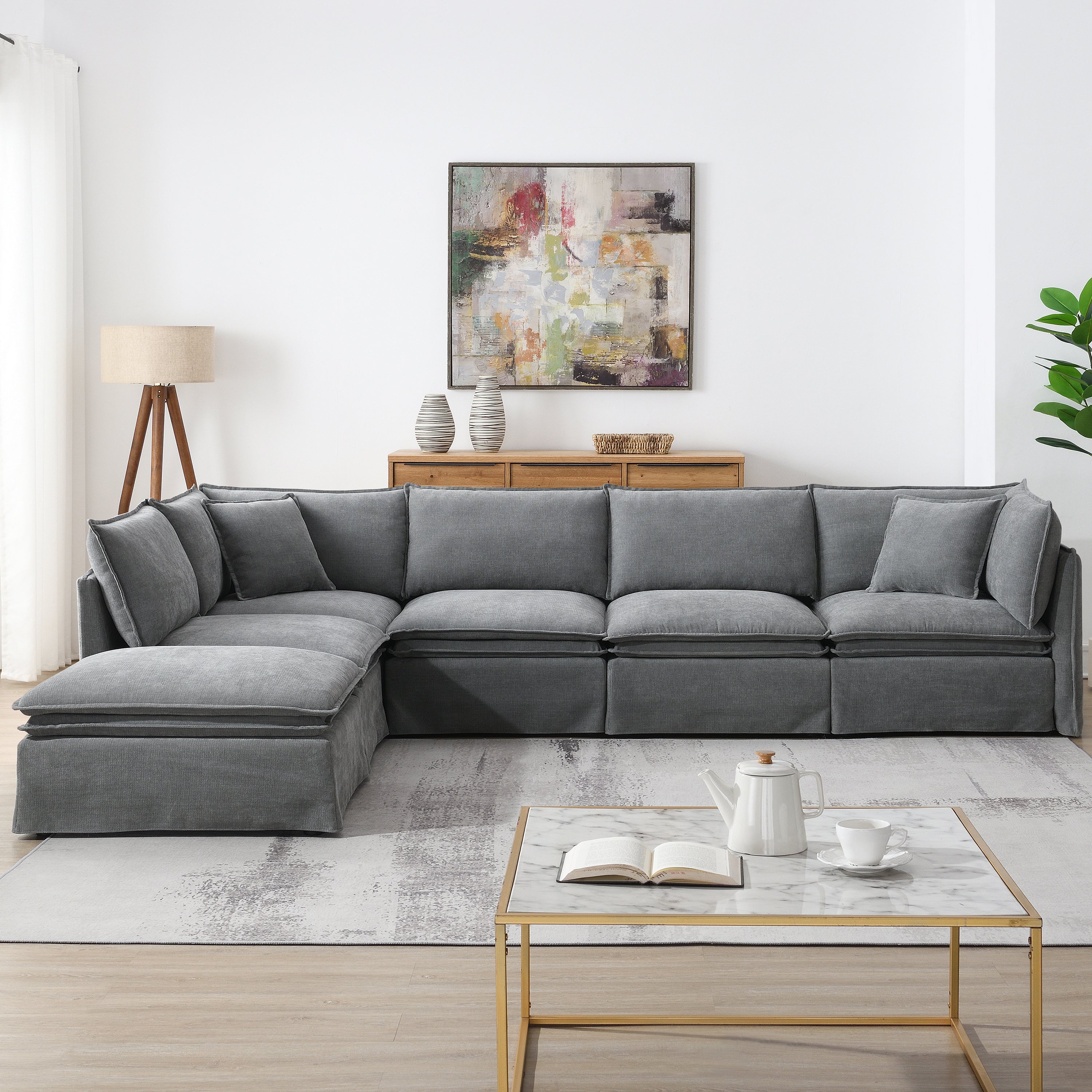 Front view of modular sectional sofa with 6 seats and ottoman in gray chenille, styled in a cozy L-shape for living room comfort.