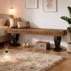 Modern rustic bench with a thick wood-grain top and black curved metal legs, placed in a cozy, styled bedroom setting.