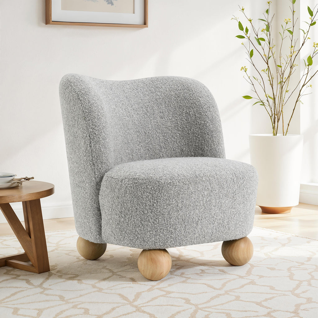 Gray accent chair upholstered in boucle fabric with round wooden legs, ideal for modern living room decor and cozy seating.