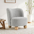 Gray accent chair upholstered in boucle fabric with round wooden legs, ideal for modern living room decor and cozy seating.