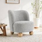 Gray accent chair upholstered in boucle fabric with round wooden legs, ideal for modern living room decor and cozy seating.