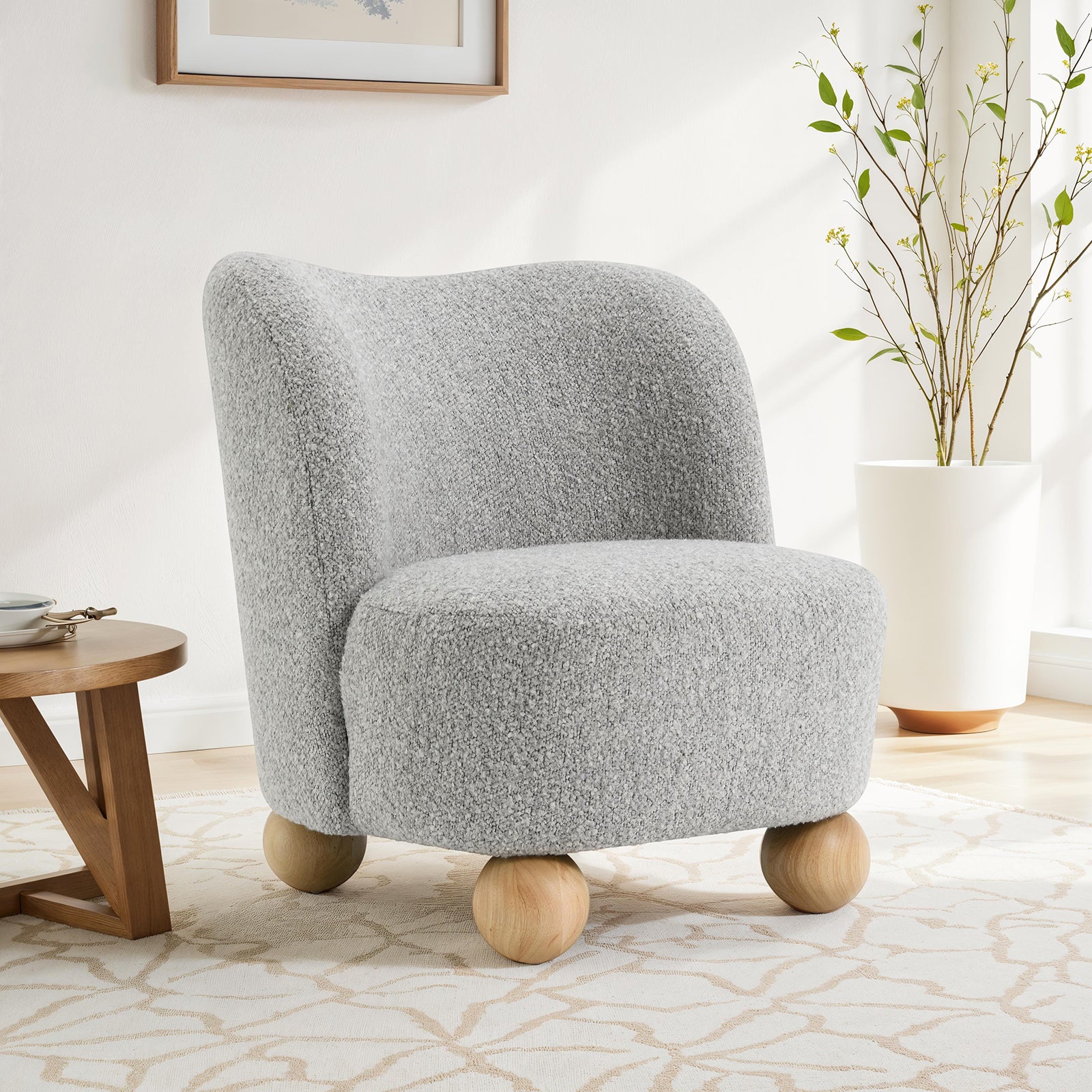 Gray accent chair upholstered in boucle fabric with round wooden legs, ideal for modern living room decor and cozy seating.