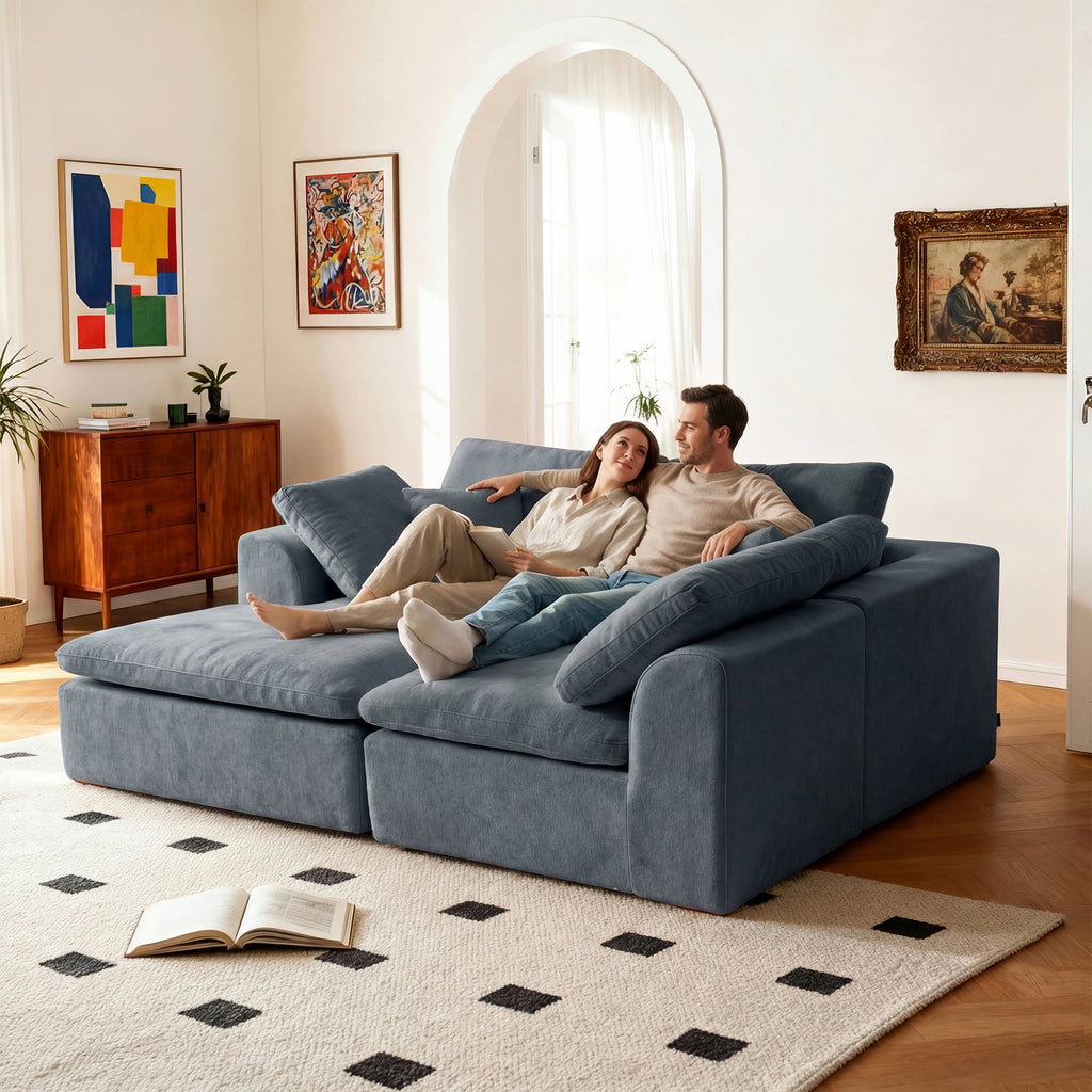 Couple lounging on wide L-shaped sectional sofa with chaise, enjoying the spacious and ergonomic seating design.