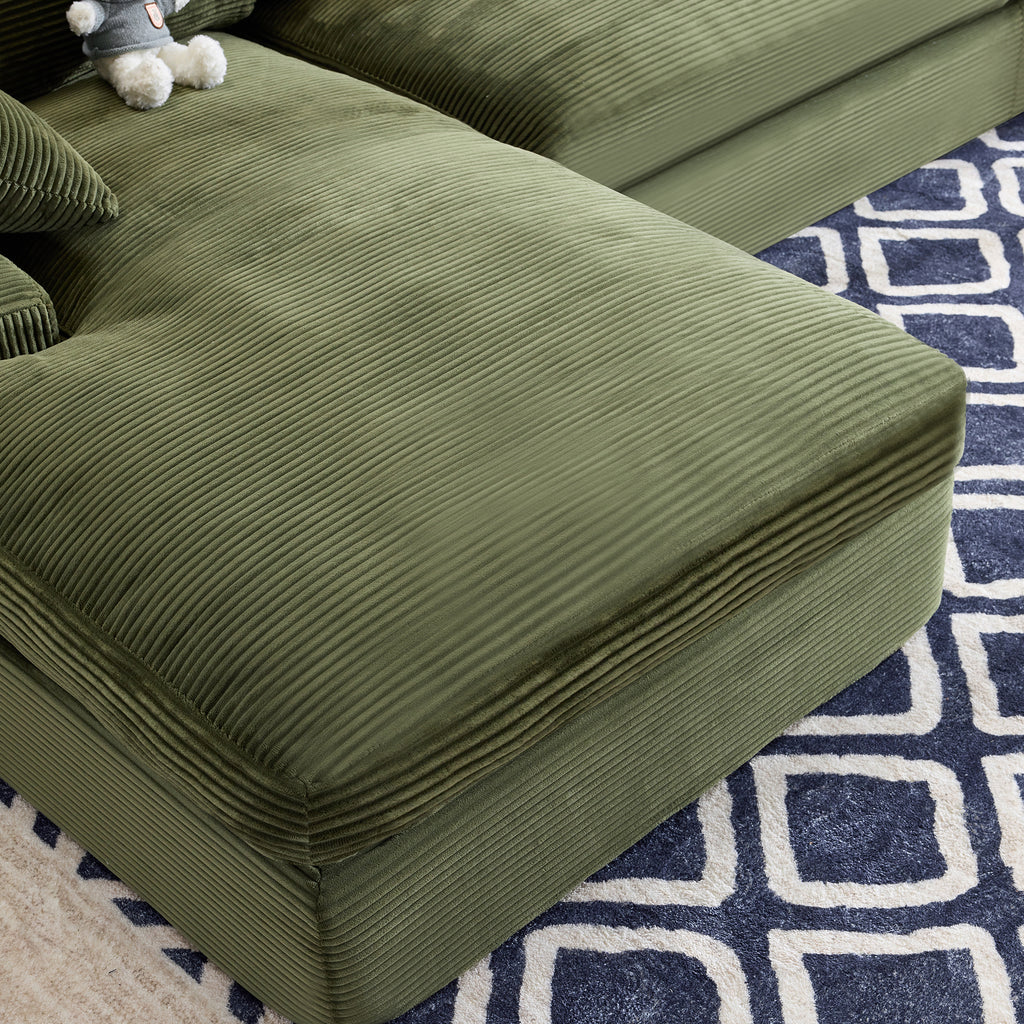 Close-up of green corduroy sofa chaise with foam-filled cushion, showcasing soft texture and modern design for cozy living rooms.