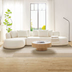 Modern beige L-shape sectional sofa with ottoman placed in a sunlit living room, showcasing its elegant curves and medium-soft seating.