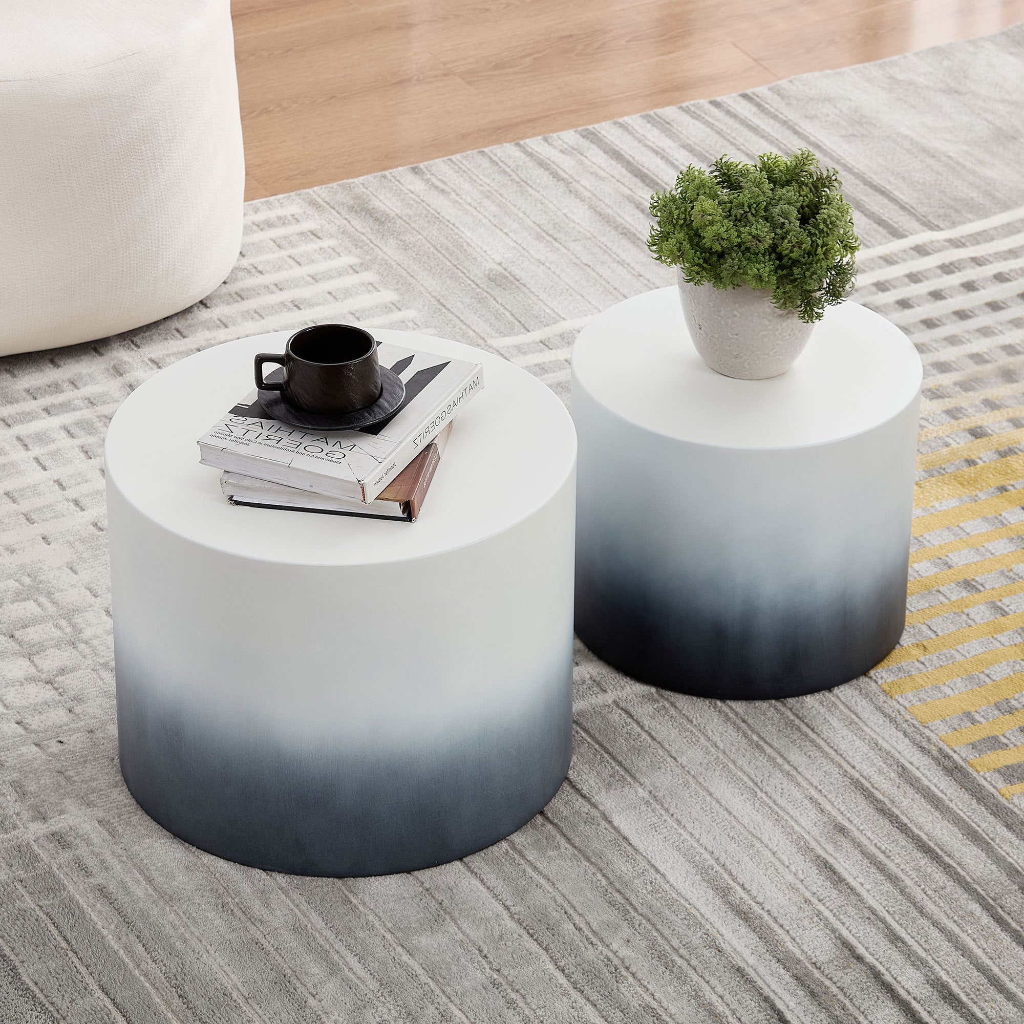 Black and white MDF Veneer nesting tables placed on a patterned rug, perfect for living room or bedroom use.