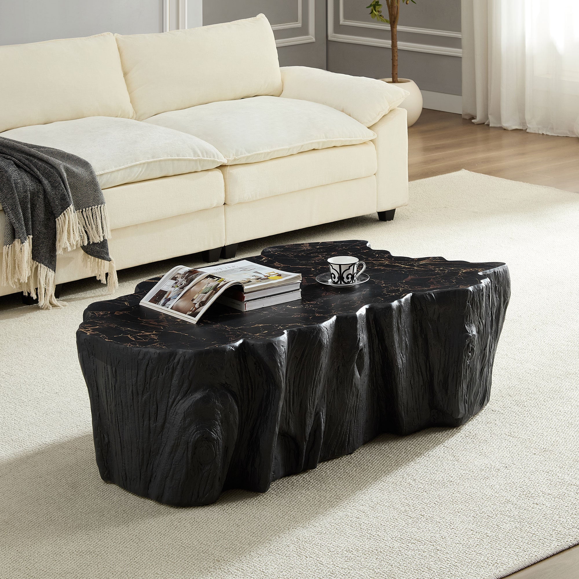 Fiberglass coffee table in mid-century modern style placed in a bright living room, showcasing its organic tree trunk shape and dark marble finish.