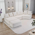 White modular U-shaped chenille sectional sofa with plush cushions in a bright, modern living room setting.