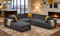 Dark gray modular sectional with deep-seated cushions, coffee bean-like texture, mustard toss pillows, and beige throws.