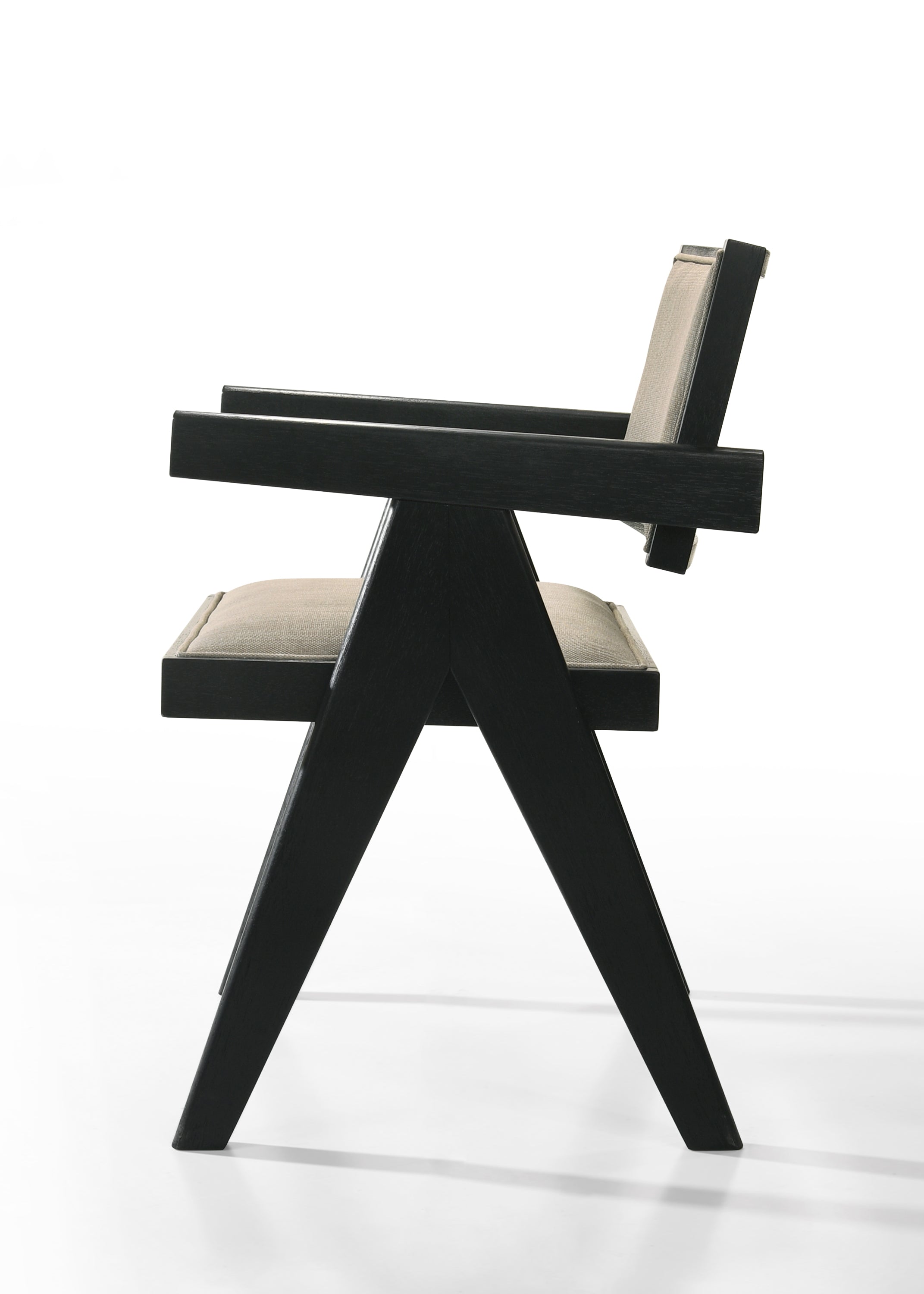 Side profile of Jasper dining chair with angular black wood frame and beige fabric upholstery. Contemporary and ergonomic.