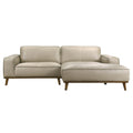 Mid-century modern beige top-grain leather sectional sofa with a right-hand chaise and walnut-finished wood legs.