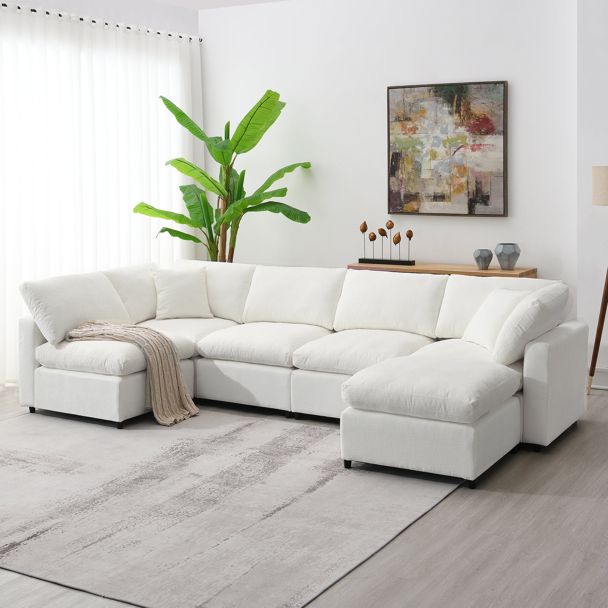 130' Modular Sofa Bed - Convertible 6 Seat Sectional in white chenille fabric, arranged in L-shape with throw blanket in modern living room.