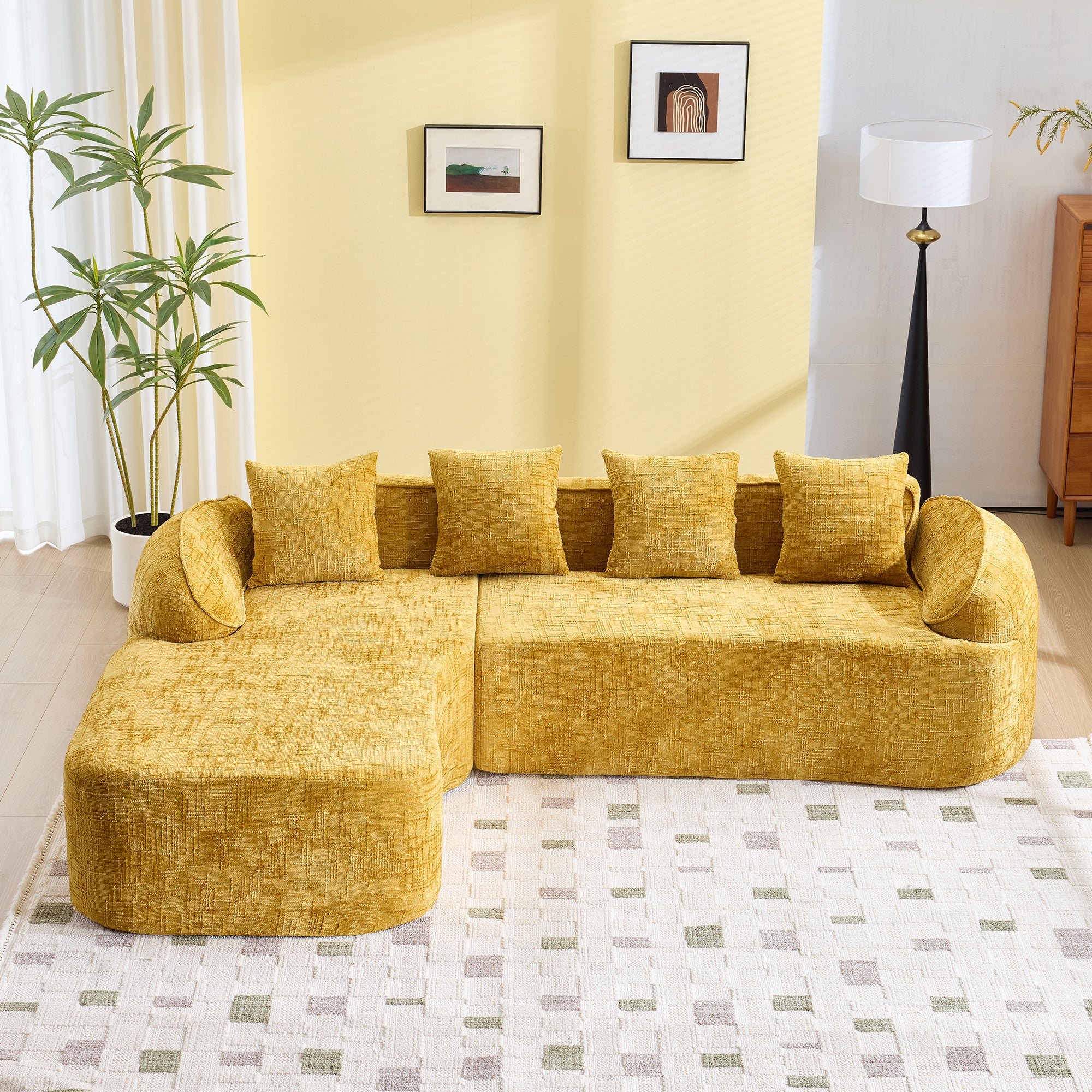 Spacious yellow chenille L-shaped sofa with soft cushions, perfect for seating four in a cozy living room setup with neutral decor.