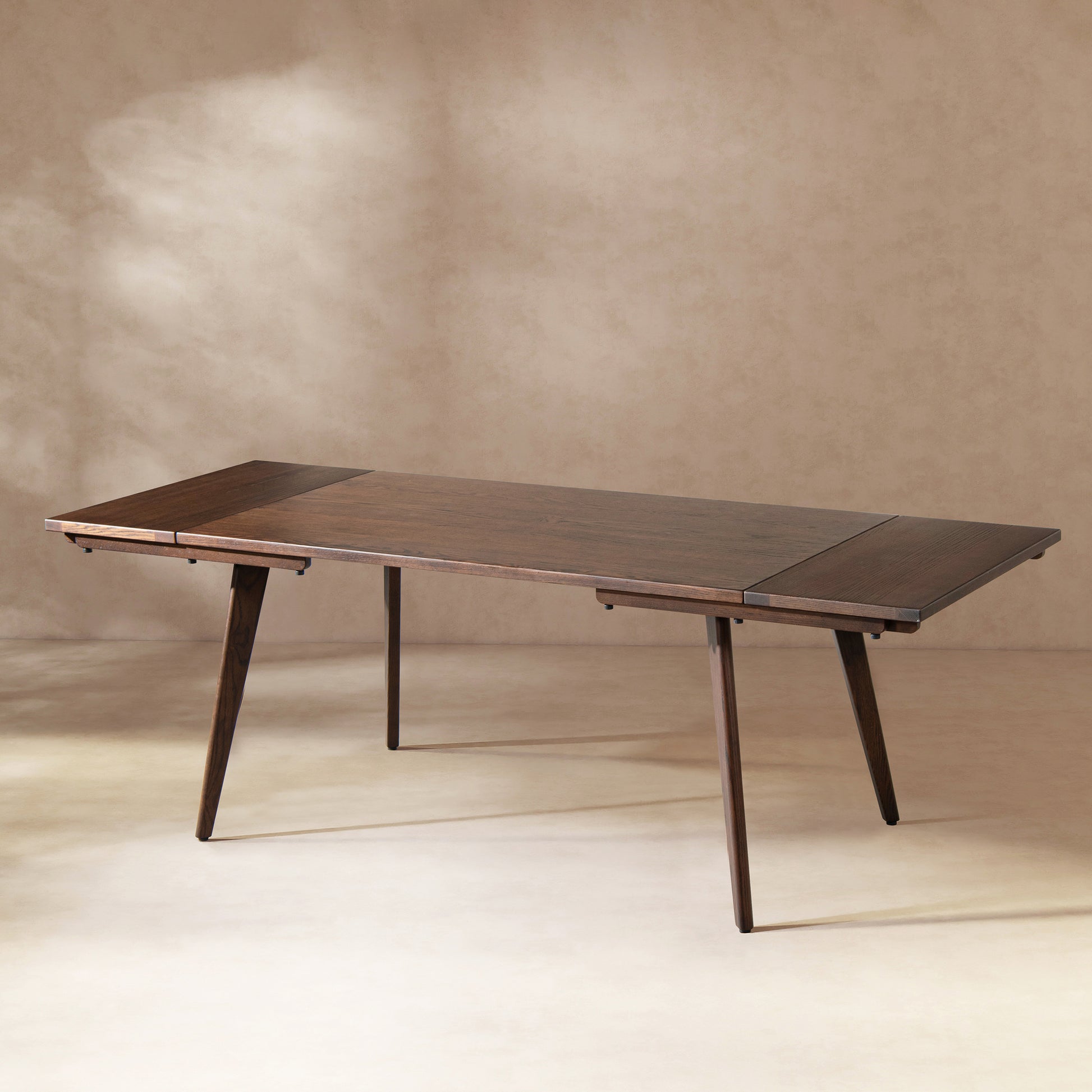 Dark brown Oak Extendable Dining Table with both leaves extended, showcasing sleek tapered legs and rich wood grain finish.