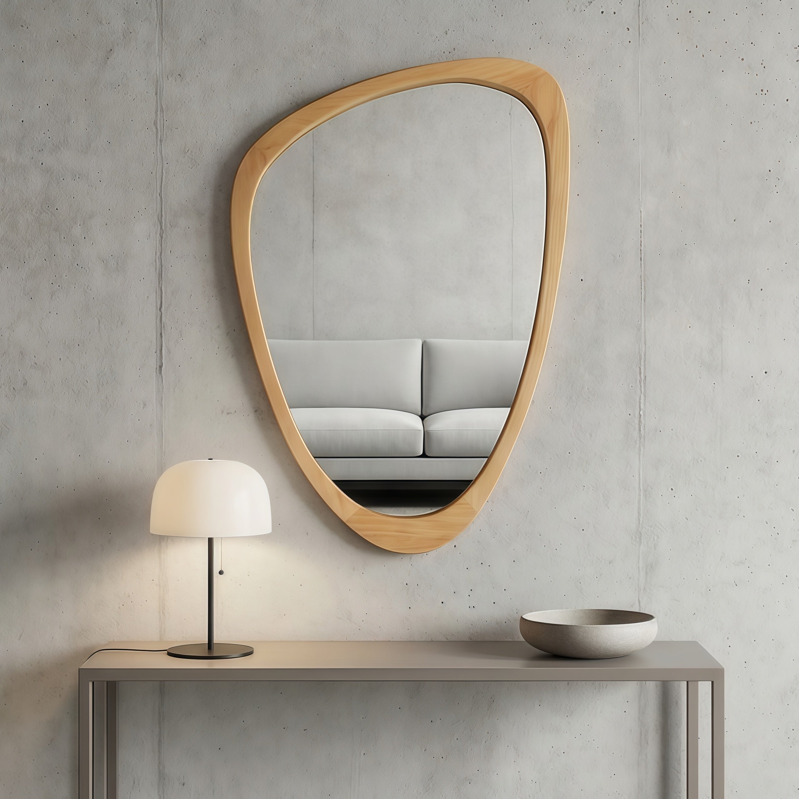Irregular oak-colored solid wood frame mirror hanging on a grey concrete wall above a minimalist console table.