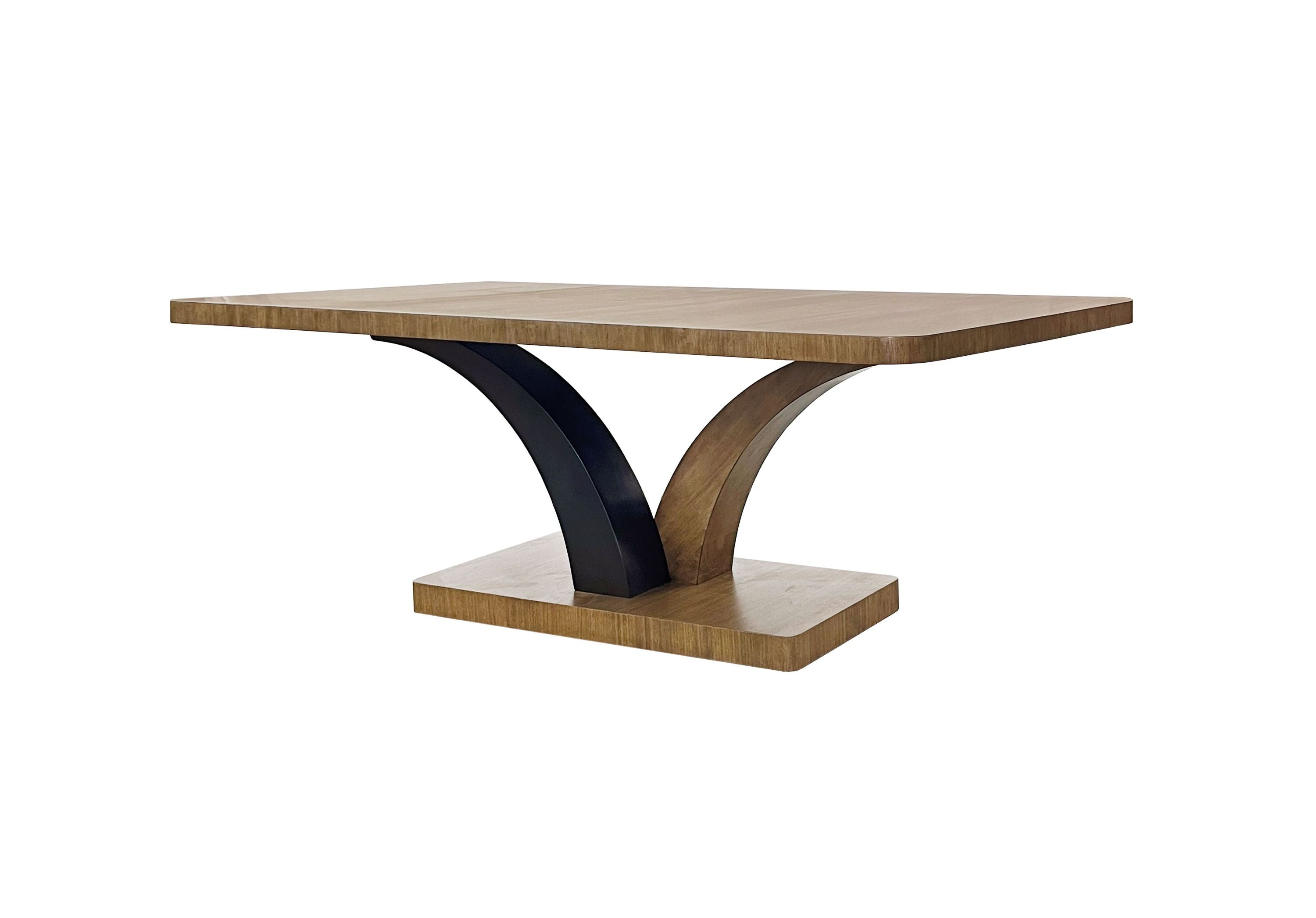 Angled view of Eucalyptus Pedestal Table with sculptural dual-arc base and rectangular top, crafted in tan solid wood for a sleek look.