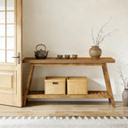 Modern minimalist 2-tier oak wood console table featuring slanted legs, a slatted bottom shelf, and two woven baskets.