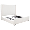 Cream California king bed frame with vertical channel tufting, nailhead trim, and a low-profile upholstered design.