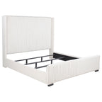 Cream California king bed frame with vertical channel tufting, nailhead trim, and a low-profile upholstered design.