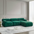 Modular L-shaped sectional sofa in green velvet with button-tufted upholstery and a reversible ottoman.