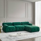 Modular L-shaped sectional sofa in green velvet with button-tufted upholstery and a reversible ottoman.