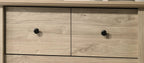 Elara 4-Drawer Light Oak Chest with Black Handles.