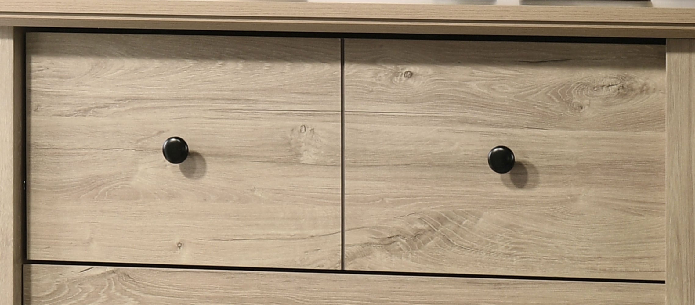 Top drawers of Elara Oak 4-Drawer Chest - Sleek Storage Solution with round black knobs and natural oak grain texture.
