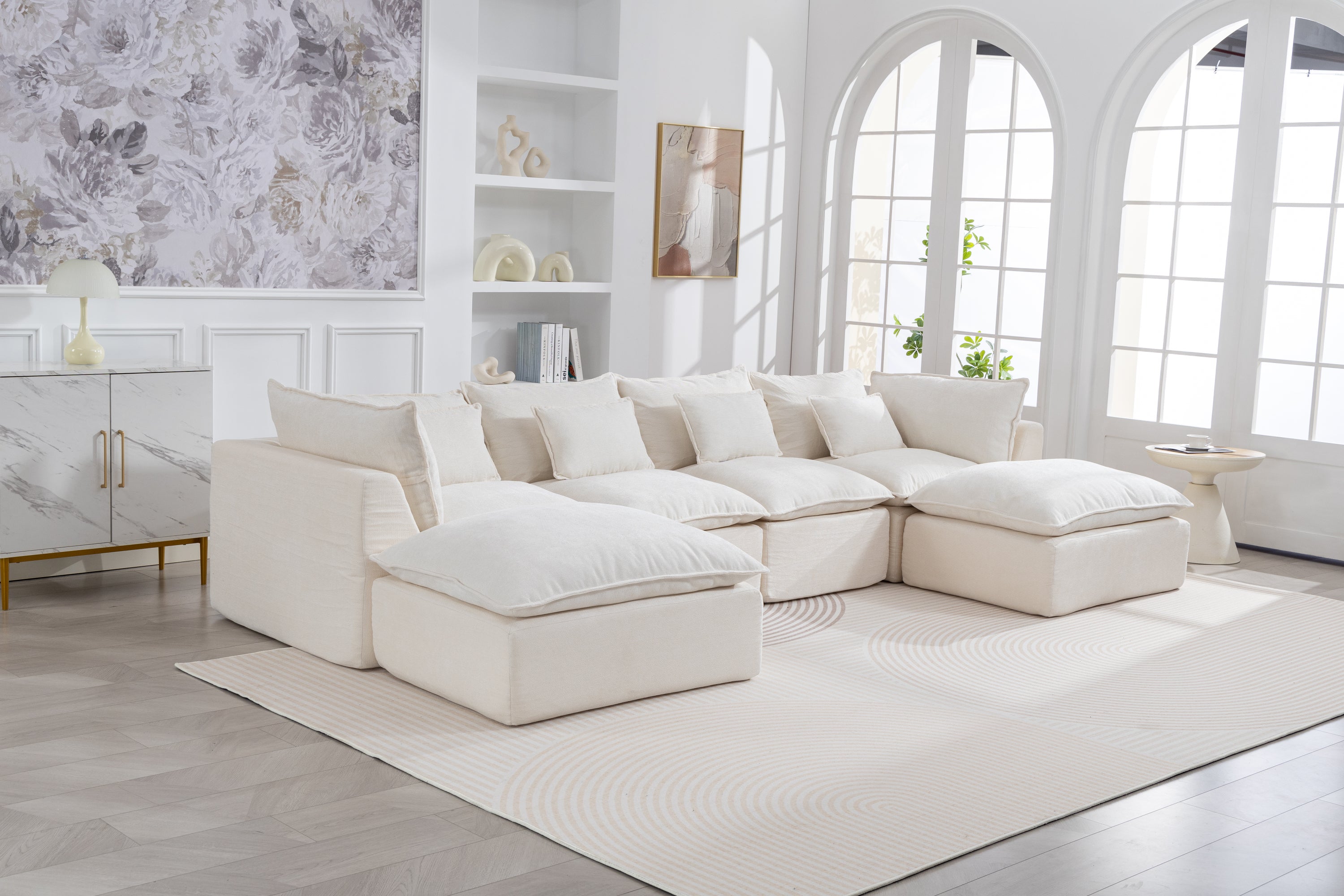 Oversized modular sectional sofa with 4 seats and 2 ottomans in a bright living room. Cloud couch design offers deep, plush seating for ultimate comfort.