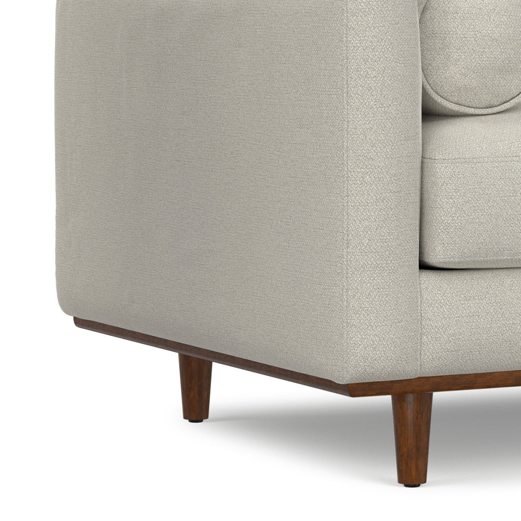 Close-up of wooden leg and lower frame on Modern Armchair Cream White - Morrison Collection, emphasizing mid-century design.