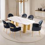 Modern dining room setup with six black dining arm chairs and a white marble table, featuring matte gold legs for a luxurious look.