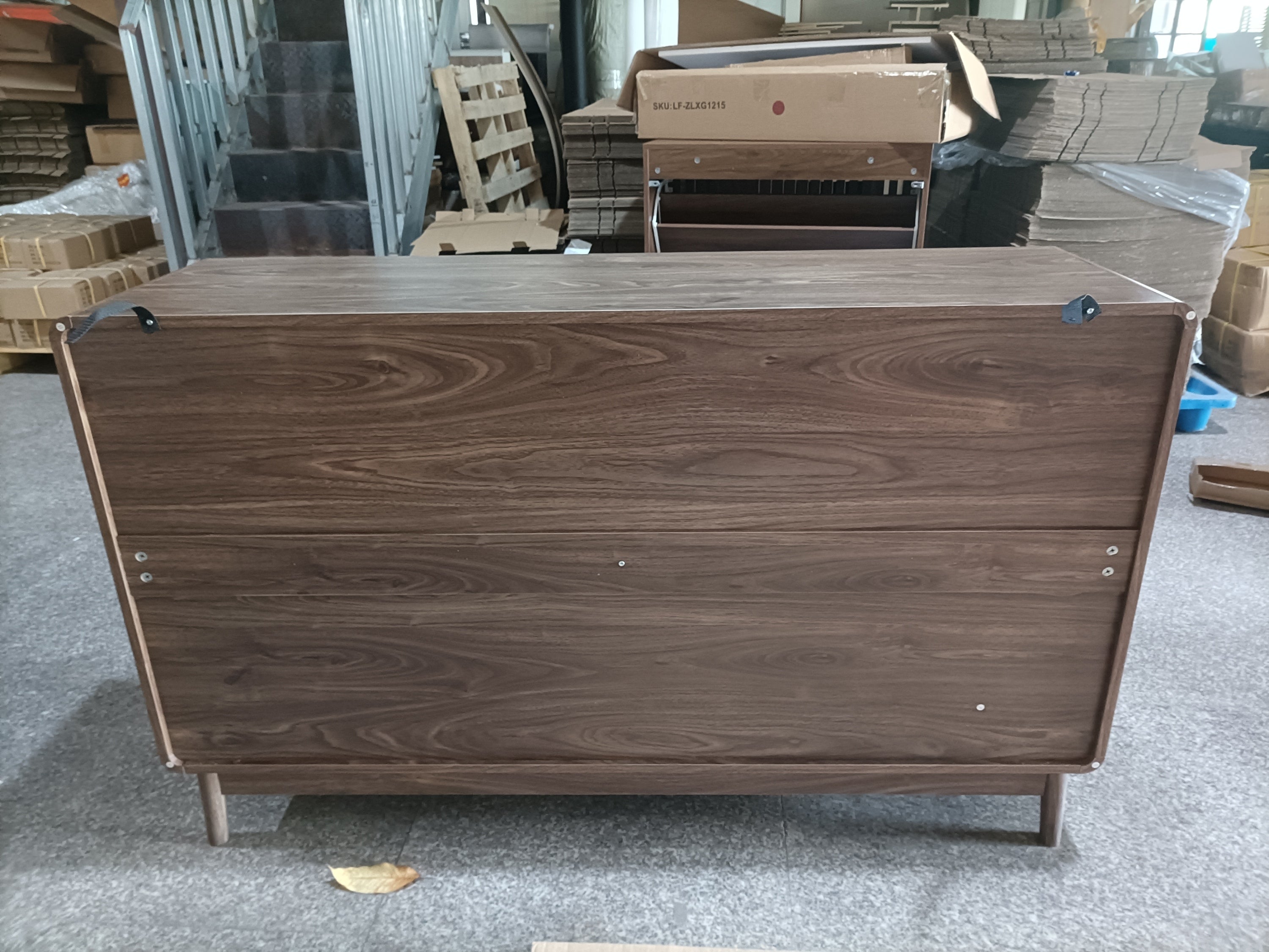 Back view of walnut buffet cabinet showing wood grain finish and construction details. Sturdy and stylish dining room storage.