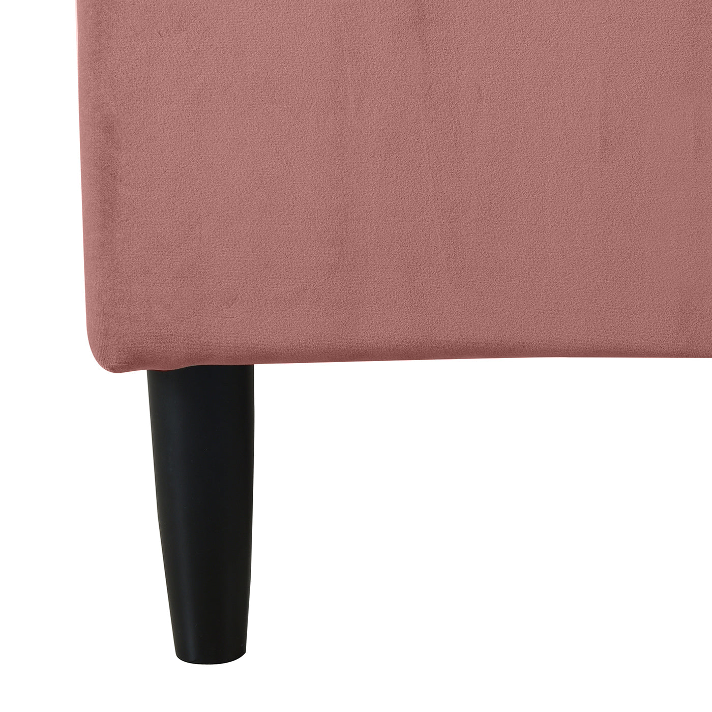 Detail of Aspen Pink Velvet Bed's black tapered leg and soft velvet upholstery. Sturdy frame with elegant finish.