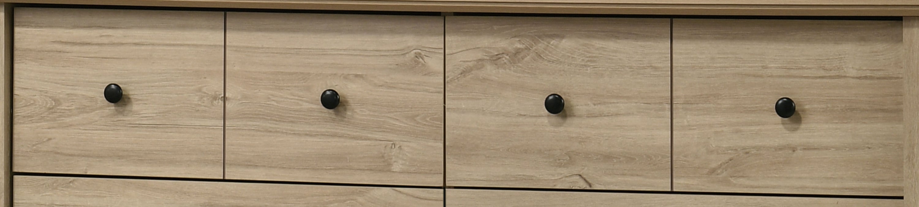 Upper drawers of Elara Light Oak Dresser with round black knobs, offering sleek modern storage design.