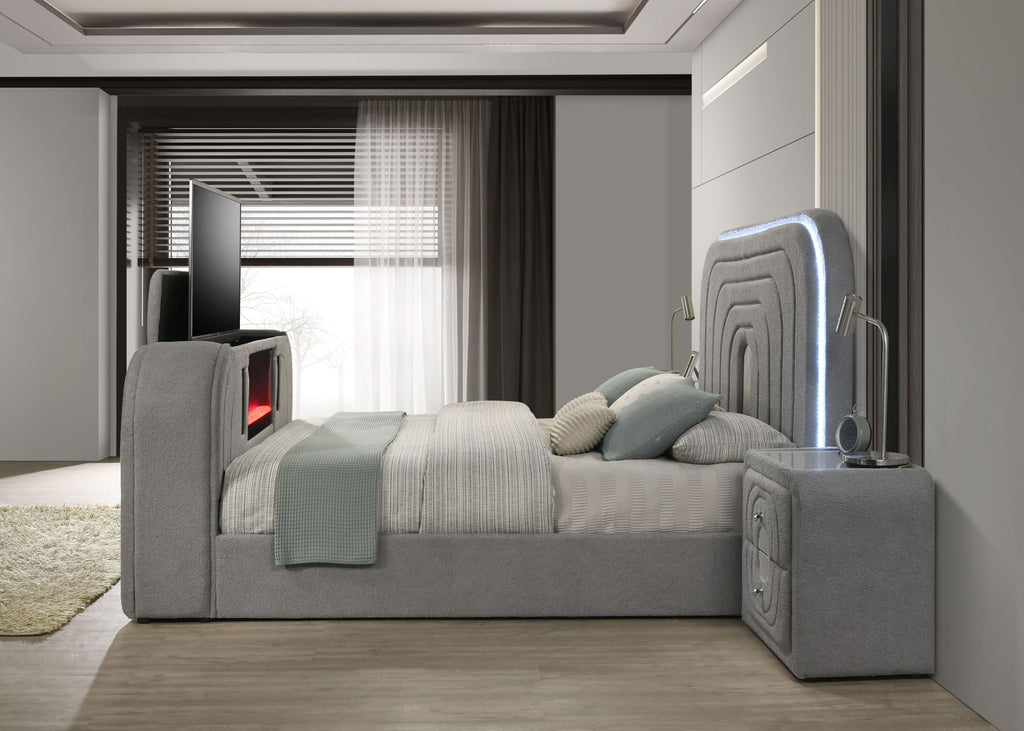 Side view of Gray Sherpa Bed featuring LED-lit headboard, TV stand, and Bluetooth speakers in a minimalist modern room.