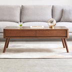 Front view of oak wood lift-top coffee table with closed top and dual drawers, placed in a modern living room.