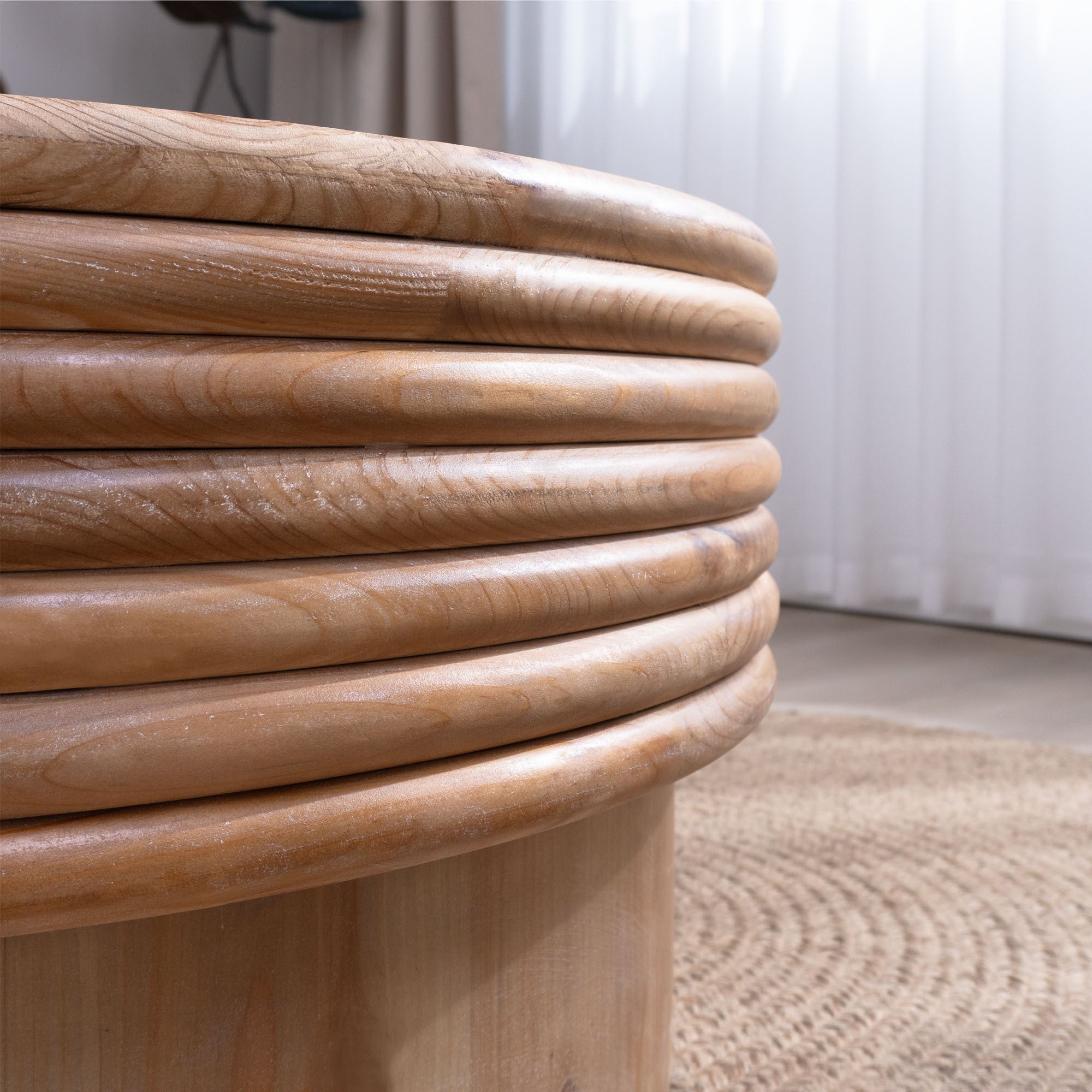 Close-up of the ribbed wood detailing on the Round Wooden Coffee Table with Storage, highlighting its handcrafted rustic design.