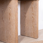 Detailed view of the Rustic Archway Console Table's leg panels, emphasizing the natural wood grain texture.