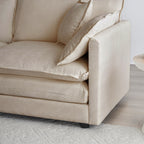 Detail of armrest and cushion on beige chenille sectional sofa. Sturdy frame and plush padding offer lasting support and style.