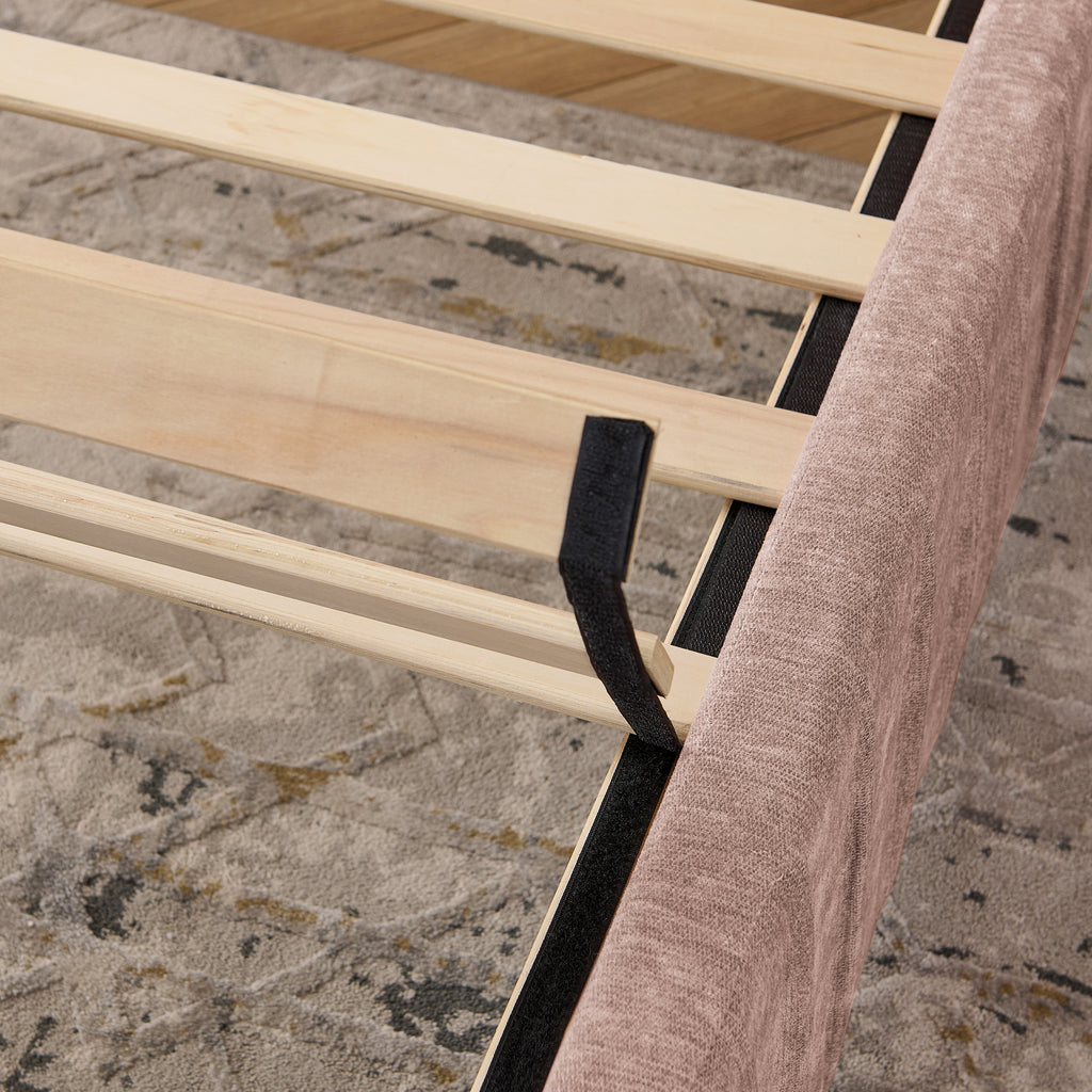 Wooden slat support system of queen upholstered bed frame, ensuring mattress stability without the need for a box spring.