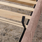 Wooden slat support system of queen upholstered bed frame, ensuring mattress stability without the need for a box spring.