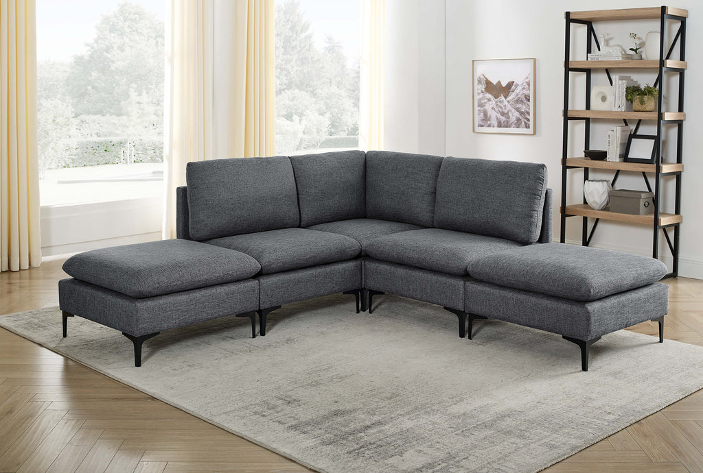 Dark gray linen upholstered modular sectional sofa with black metal legs in a sunlit living room.