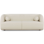 Modern white boucle sofa with curved silhouette, two round bolster pillows, and subtle wood legs.