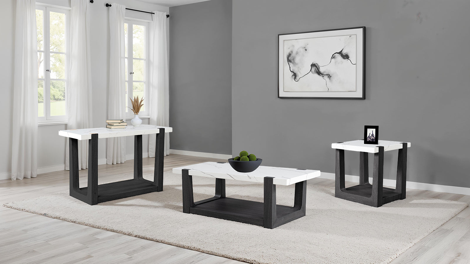 Modern coffee table faux marble set with matching end tables in a coordinated two-tone black and white living room ensemble.