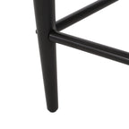 Close-up of black iron leg on modern counter stool, highlighting sturdy and sleek construction.