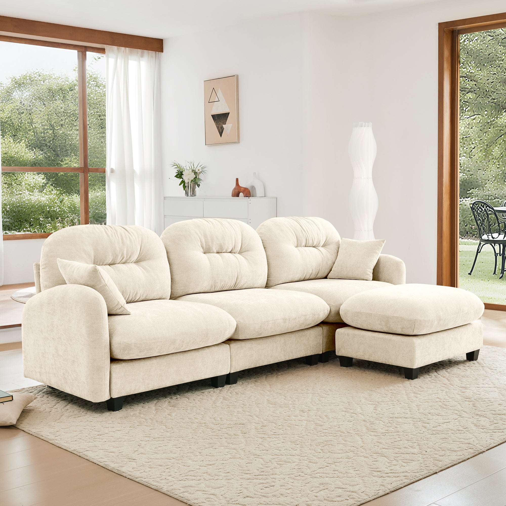 Chenille fabric modular L-shaped sectional couch with ottoman, placed in a modern living space with large windows and soft lighting.