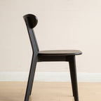 Side profile of Solid Oak Dining Chair in black, highlighting its ergonomic seat and angled legs for stability and comfort.