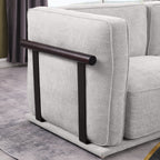 Side view of modular fabric sofa armrest with dark wood and metal support, blending modern aesthetics with functional design.