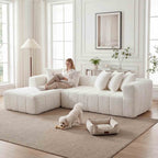 Modern off-white, L-shaped sectional sofa with plush, tufted upholstery and deep seating in a bright, airy living room.