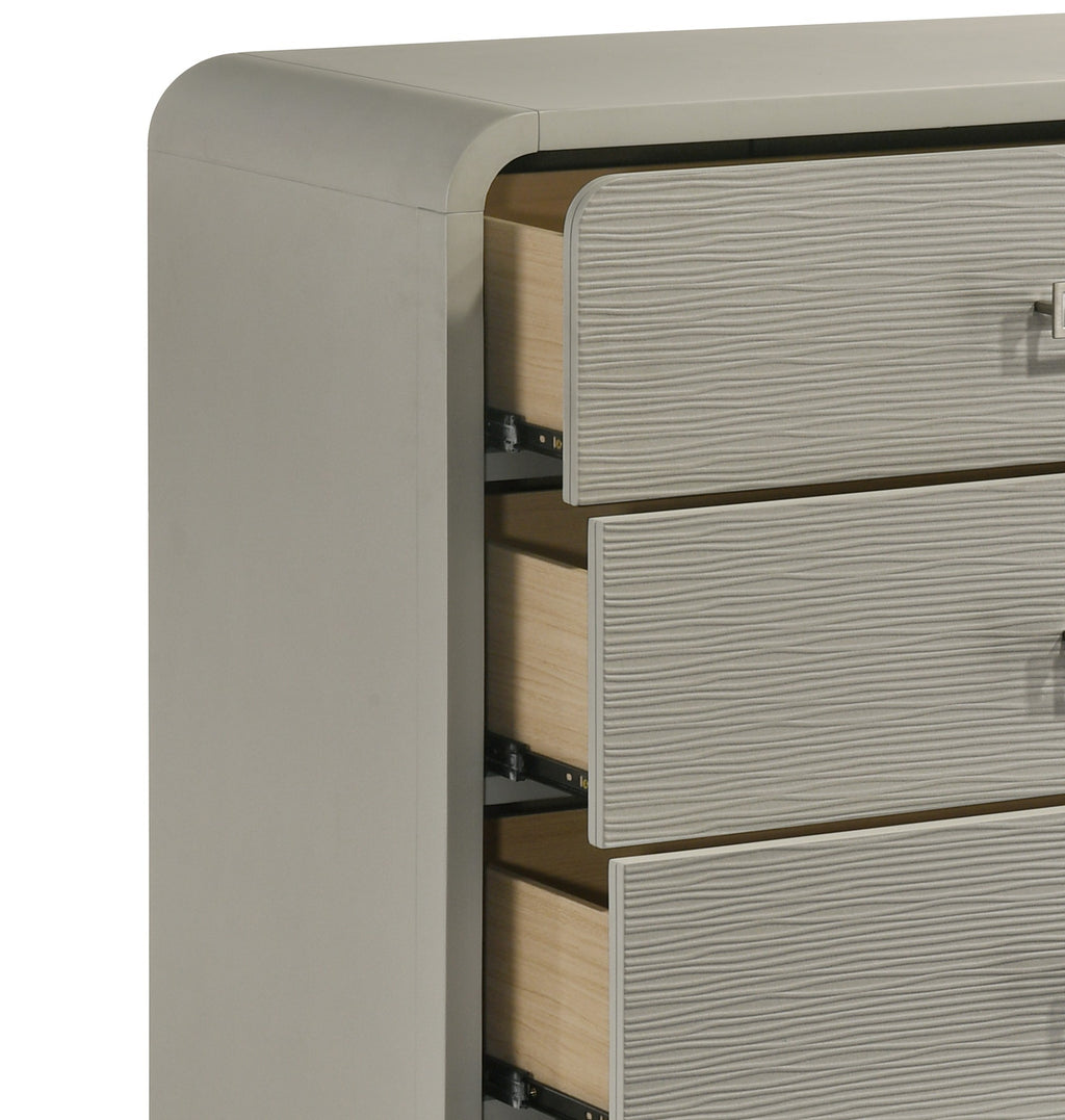 Close-up of Aria chest drawer construction, showing textured front panels, metal handles, and durable ball bearing glides for smooth operation.